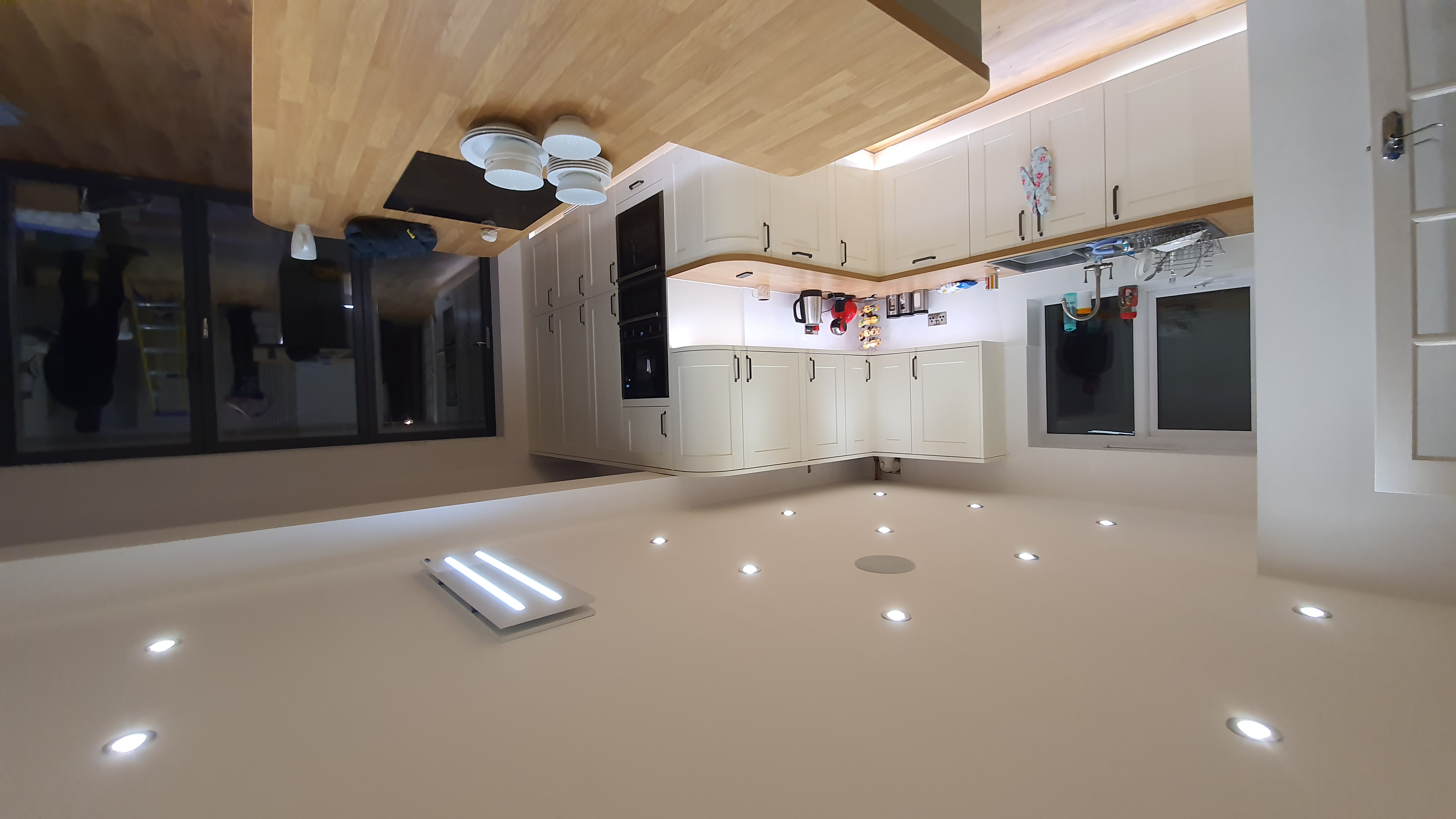 Finished kitchen installation with recessed downlights and under-cabinet lighting